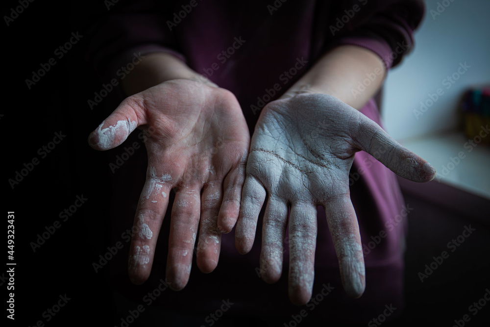 beautiful women's hands smeared in white paint after working with their