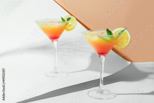 Glasses of tasty summer cocktail on color background