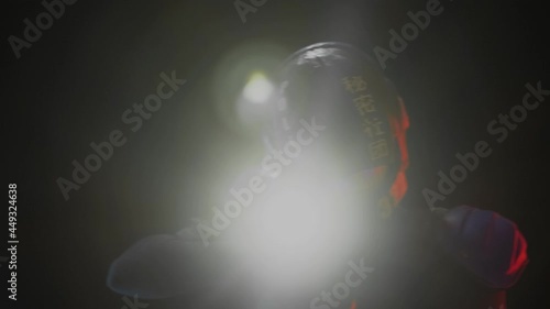 Cyberpunk future concept. Police officer cop, bionic cyborg aims weapon gun with lantern in dark. Halfman walk along camera and leaves frame. Science fiction scene, fantasy, sci. Law, Order photo