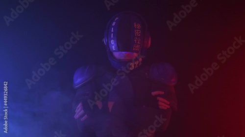 Cyberpunk future concept. Portrait of bionic cyborg police officer in dark with smoke, fume. Halfman robot looks at camera. Futuristic science fiction scene, sci. Red blue light blinks. Law, Order photo