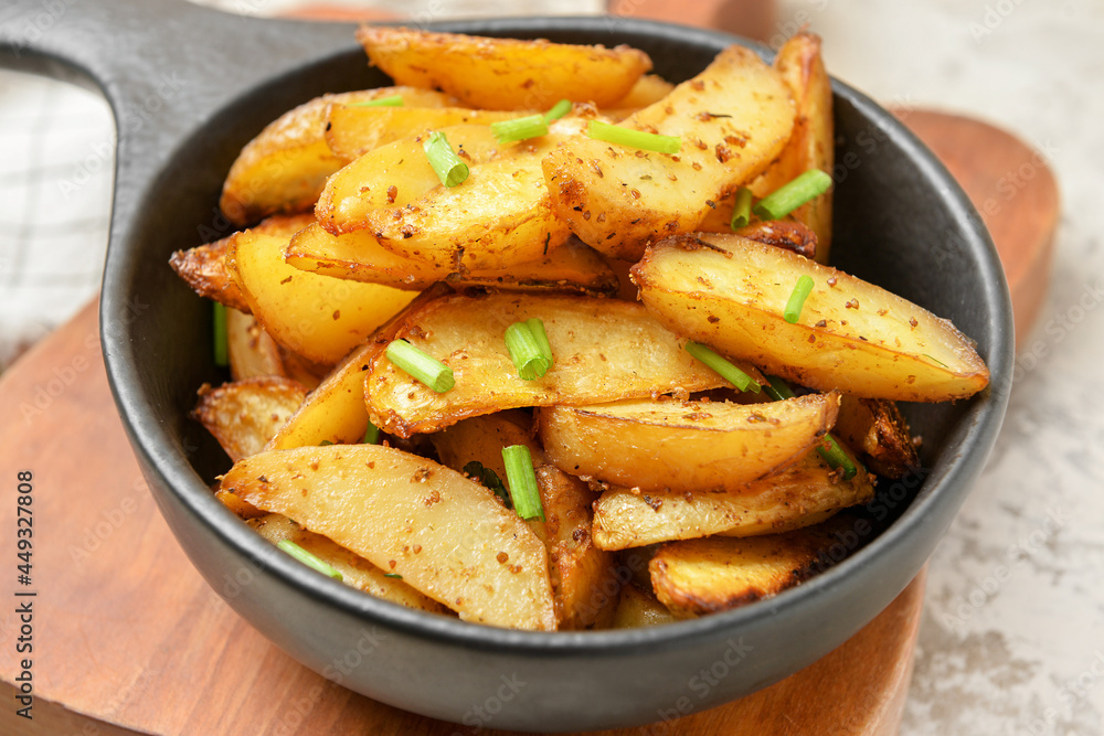 Baking dish with tasty potato on table, closeup Baking dish with tasty potato on table, closeup