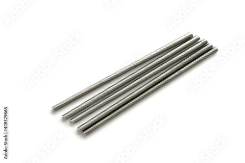 Stainless steel threaded rod on white background.