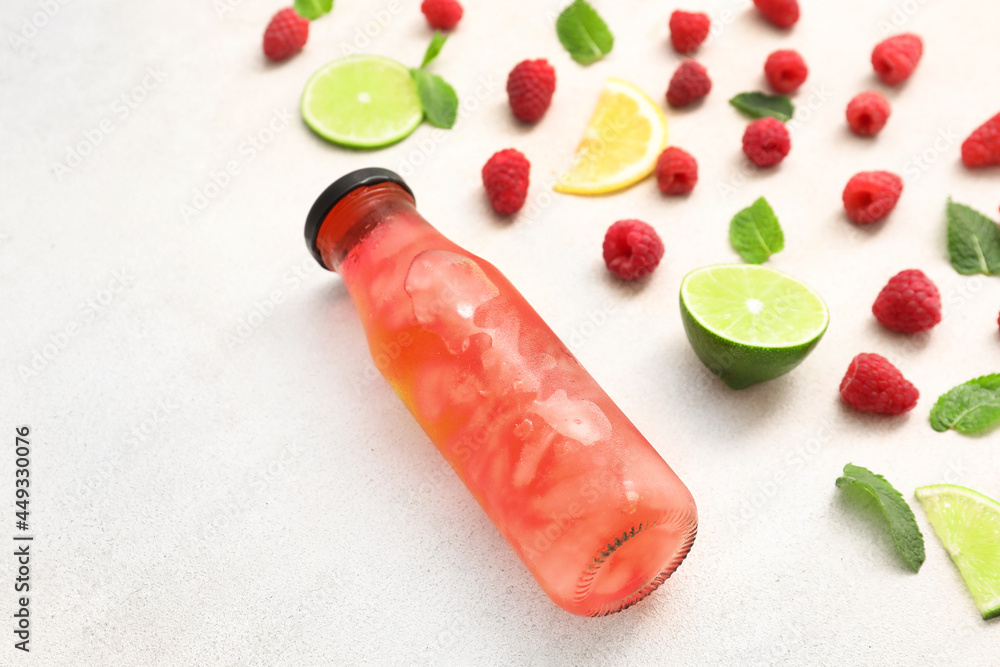 Bottle of delicious lemonade with raspberry on white background Bottle of delicious lemonade with raspberry on white background