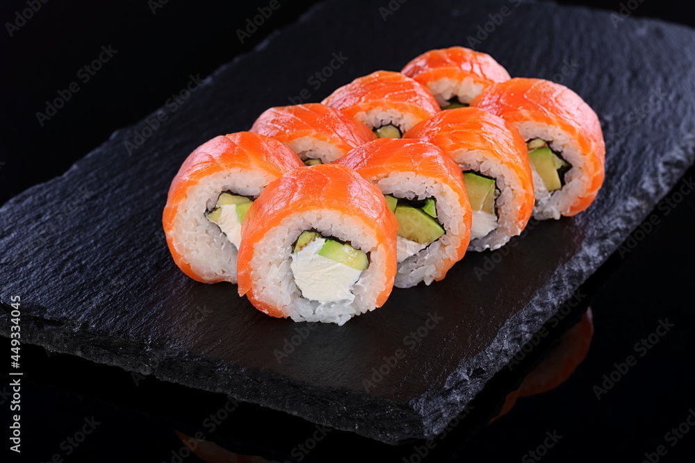Rolls with red caviar on a black background Rolls with red caviar on a black background