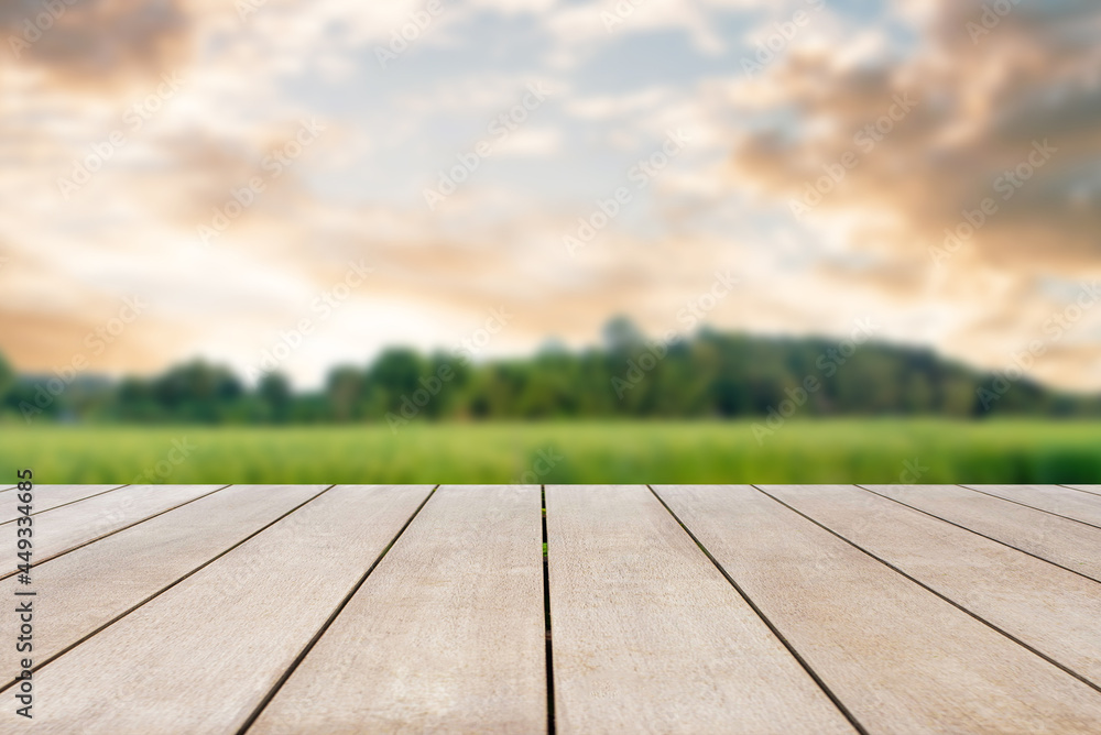 Empty old wooden table in front of blurred view of grassland, tree, cloud and mountain with beautiful view sunset nature background. Can be used for display or montage for show your products. Empty old wooden table in front of blurred view of grassland, tree, cloud and mountain with beautiful view sunset nature background. Can be used for display or montage for show your products.