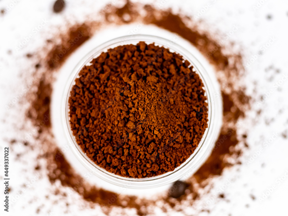 Extreme closeup shot of coffee powder in glass bowl with defocused circle on the background. Extreme closeup shot of coffee powder in glass bowl with defocused circle on the background.
