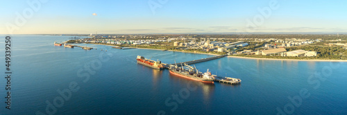 horizontal shot of Kwinana bulk jetty with two large ships docked at the port