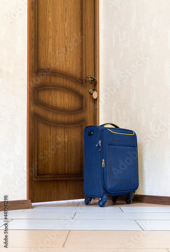 Suitcase is near door