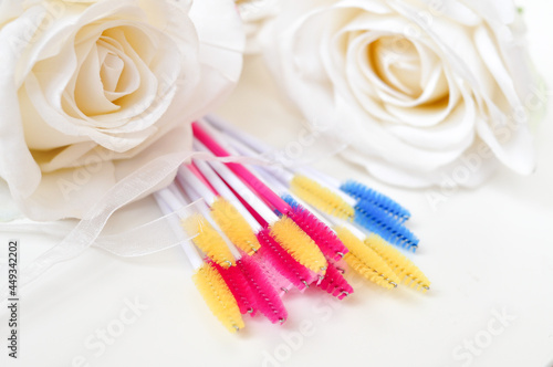 colored brushes for lash extensions in beauty salon materials for lashmaker on white background  copy space
