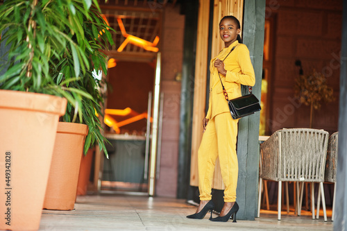 Portrait of nice-looking fashionable attractive lovely content cheerful cheery african american girl wear bright vivid shine vibrant yellow color jacket or costume. © AS Photo Family
