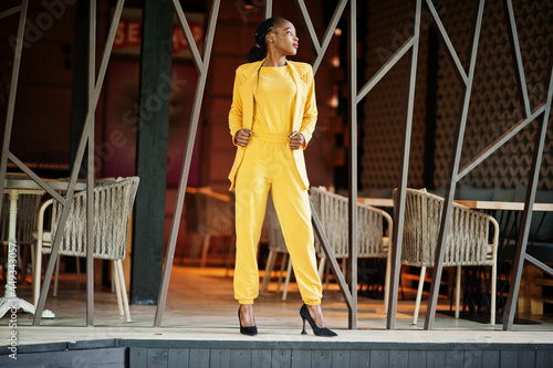 Portrait of nice-looking fashionable attractive lovely content cheerful cheery african american girl wear bright vivid shine vibrant yellow color jacket or costume.