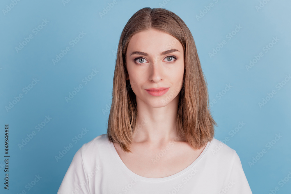 Portrait of charming gorgeous lovely girl look camera posing on blue background Portrait of charming gorgeous lovely girl look camera posing on blue background