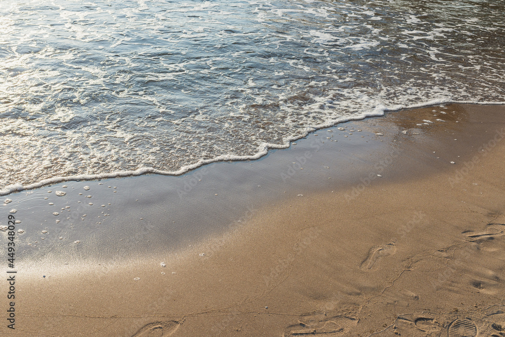 Soft wave of the sea on the sandy evening beach.Soft focus,blurred image. Soft wave of the sea on the sandy evening beach.Soft focus,blurred image.