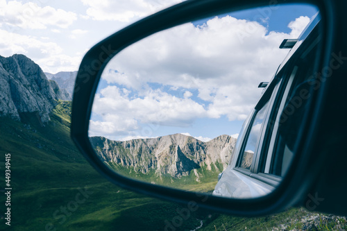 Driving off road car in high altitude forest mountains