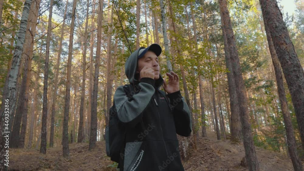 Man Playing Harp in Forest. Young Man Playing on Vargan Authentic Ethnic Music. Musician Artist Relaxing Outdoors. Green Tourism. Eco Traveling Concept Man Playing Harp in Forest. Young Man Playing on Vargan Authentic Ethnic Music. Musician Artist Relaxing Outdoors. Green Tourism. Eco Traveling Concept