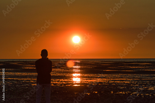silhouette of a person on the beach at sunset