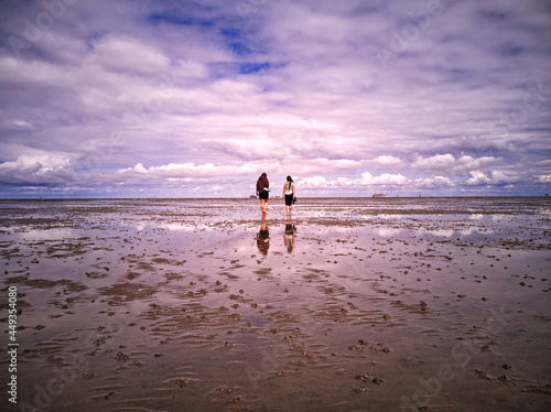 two girls walking on the beach