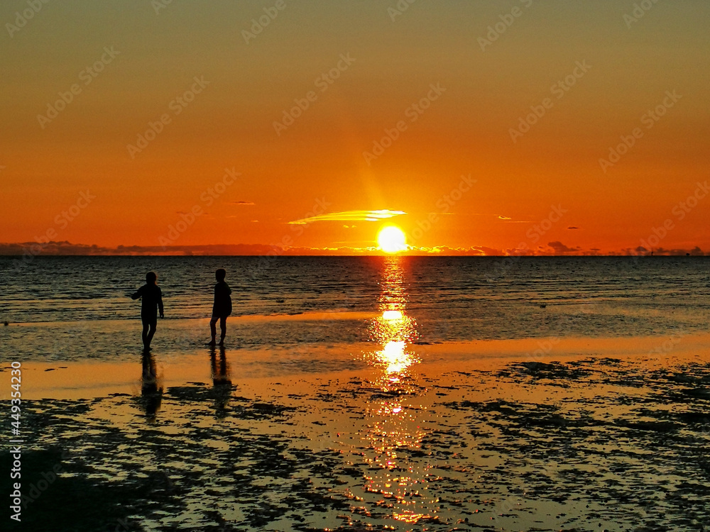  kids play sunset on the beach