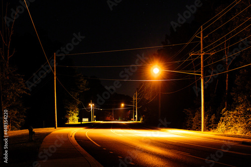 Fototapeta Naklejka Na Ścianę i Meble -  Solomons, Maryland USA  A small road with street lamps.