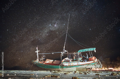 Grounded ship in the night and starry sky 