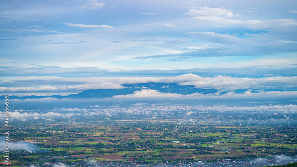 Fototapeta premium Unseen view point,White fog in the countryside and big mountains in Chiang Mai, Thailand, Blue clouds and vapor from the humid air after the rain, giving a soothing feeling.