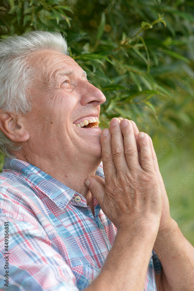 portrait of a senior man laughing portrait of a senior man laughing