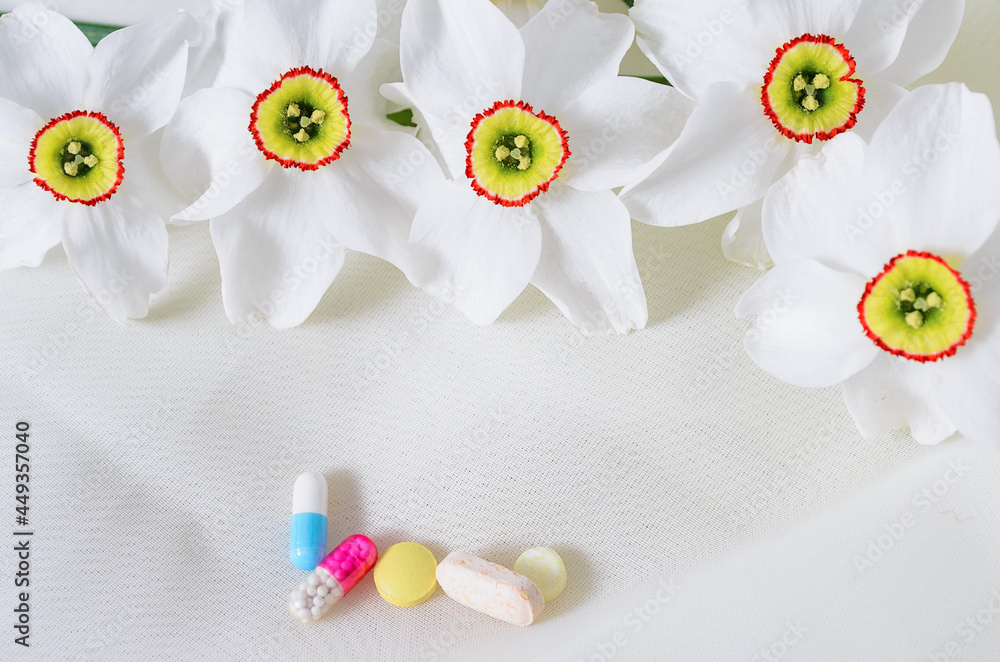 Treatment for various diseases. Tablets with flowers on a white background Treatment for various diseases. Tablets with flowers on a white background