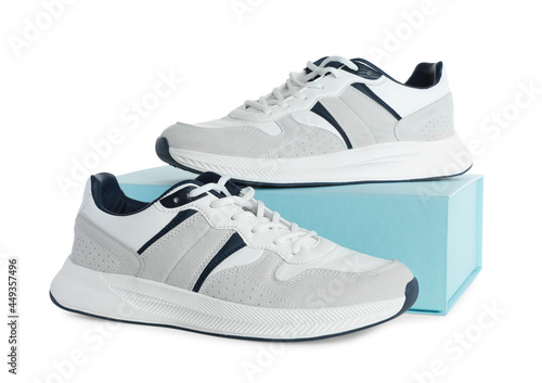 Pair of stylish sport shoes and turquoise box on white background
