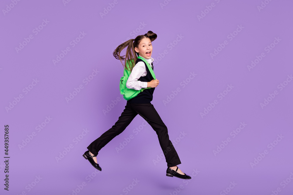 Photo of glad cheerful impressed schoolgirl jump run wear rucksack uniform isolated violet color background
