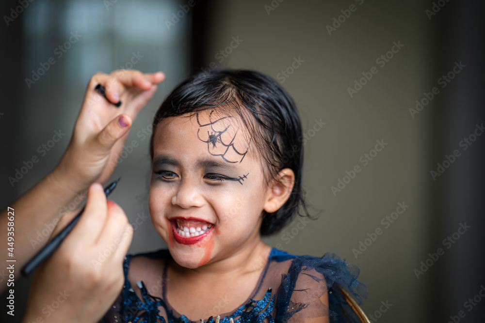 Fototapeta premium Mother Painting Daughters Face. Halloween Party.
