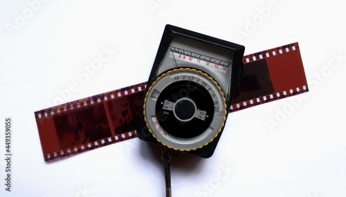 Obraz na plátně An analog exposure meter for the camera and a piece of analog photographic film
