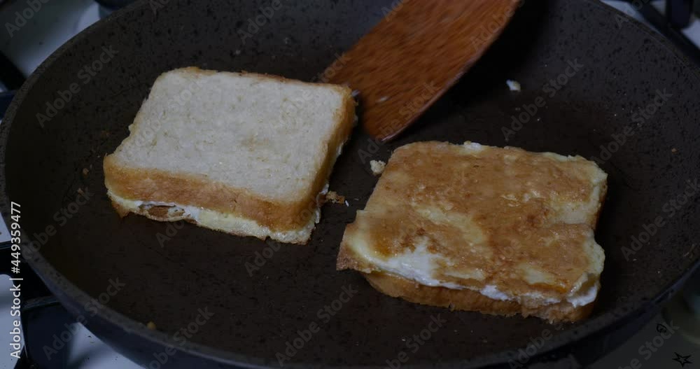 Brioche toast bread is slowly fried in a hot frying pan Brioche toast bread is slowly fried in a hot frying pan