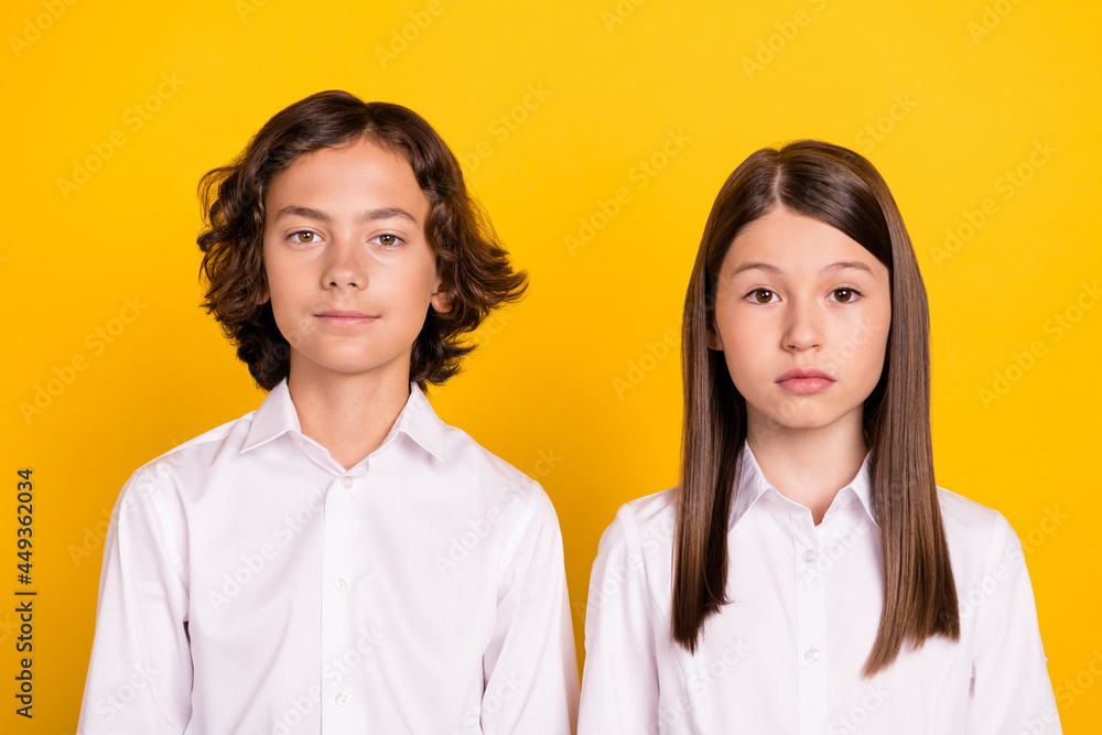 Photo of calm schoolkids look camera prepare gymnasium wear white shirt isolated yellow color background Photo of calm schoolkids look camera prepare gymnasium wear white shirt isolated yellow color background