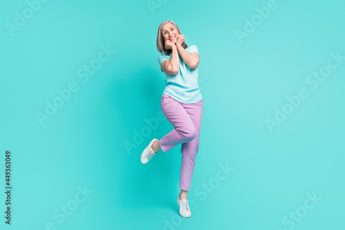 Full size photo of mature funky funny cheerful gorgeous woman adore admire enjoy weekend isolated on turquoise color background