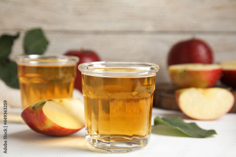 Glass of delicious apple cider on white table. Space for text Glass of delicious apple cider on white table. Space for text