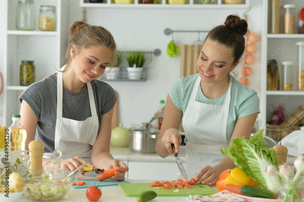 Portrait of beautiful teenagers cooking in kitchen Portrait of beautiful teenagers cooking in kitchen