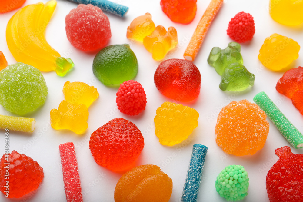 Mix of different delicious gummy candies on white background, flat lay Mix of different delicious gummy candies on white background, flat lay