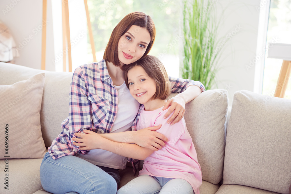 Photo of positive happy people siblings smile good mood hug sit sofa indoors inside house home apartment Photo of positive happy people siblings smile good mood hug sit sofa indoors inside house home apartment