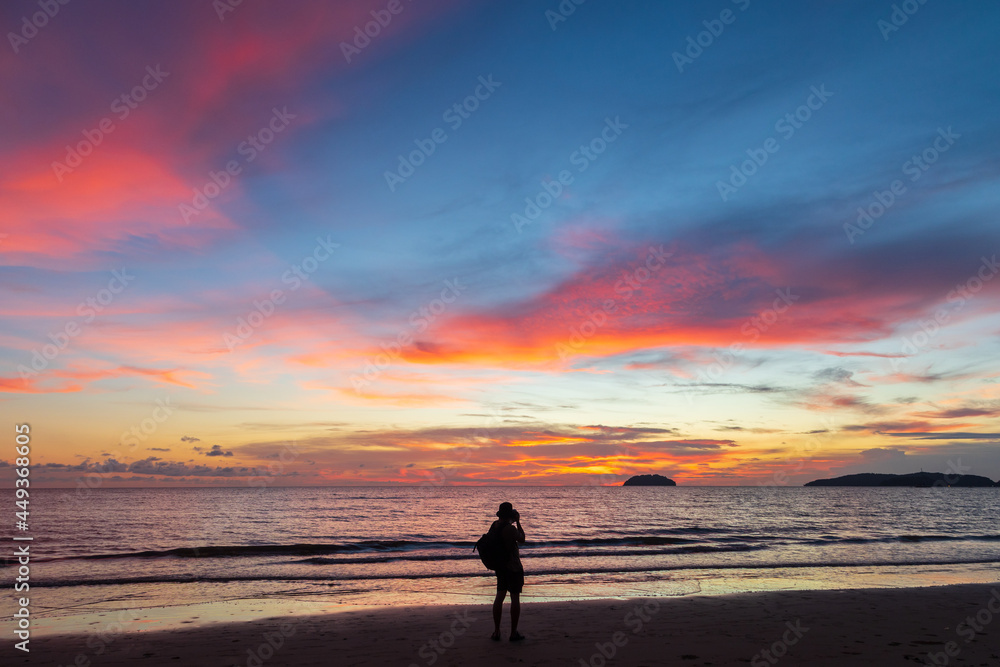 Unidentified Photographer taking a beautiful twilight sunset at Tanjung aru beach, Sabah, Malaysia