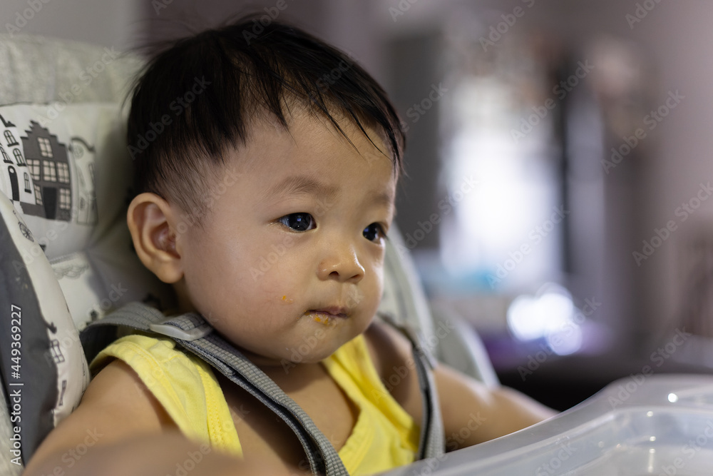 Portrait image of adorable and cute happy Asian Chinese baby boy siting on baby chair Portrait image of adorable and cute happy Asian Chinese baby boy siting on baby chair