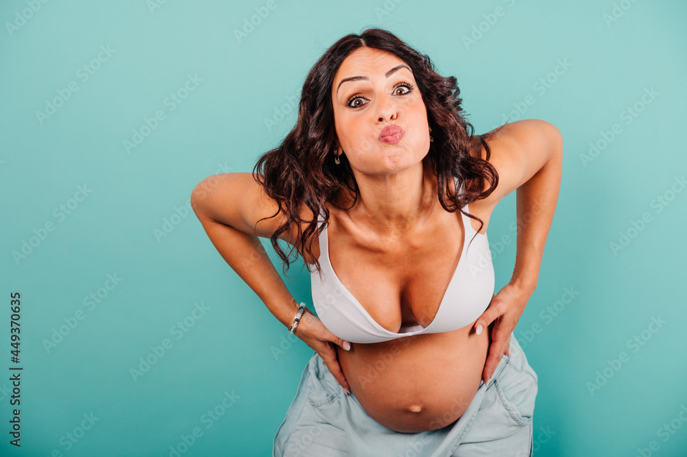 Pregnant woman expecting a child caresses her belly Pregnant woman expecting a child caresses her belly