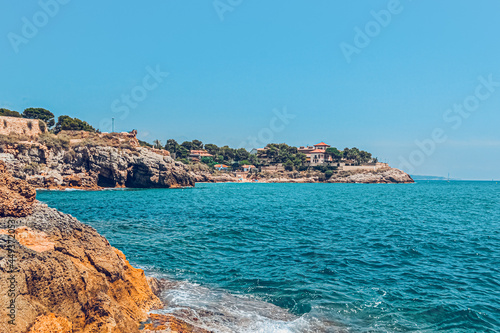 Tarragona Spain July 10, 2017 Sea landscape. Scenic old town with nice sand beach and clear blue water in bay. photo