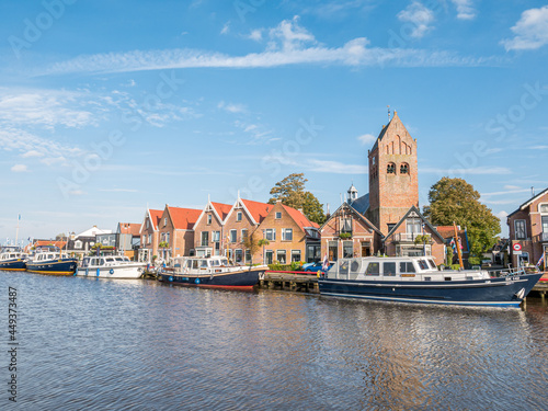 Boats, houses and church tower in town of Grou, Friesland, Netherlands photo