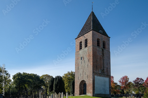 The cemetery of Joure, Friesland with medieval church tower, Friesland province, The Netherlands photo