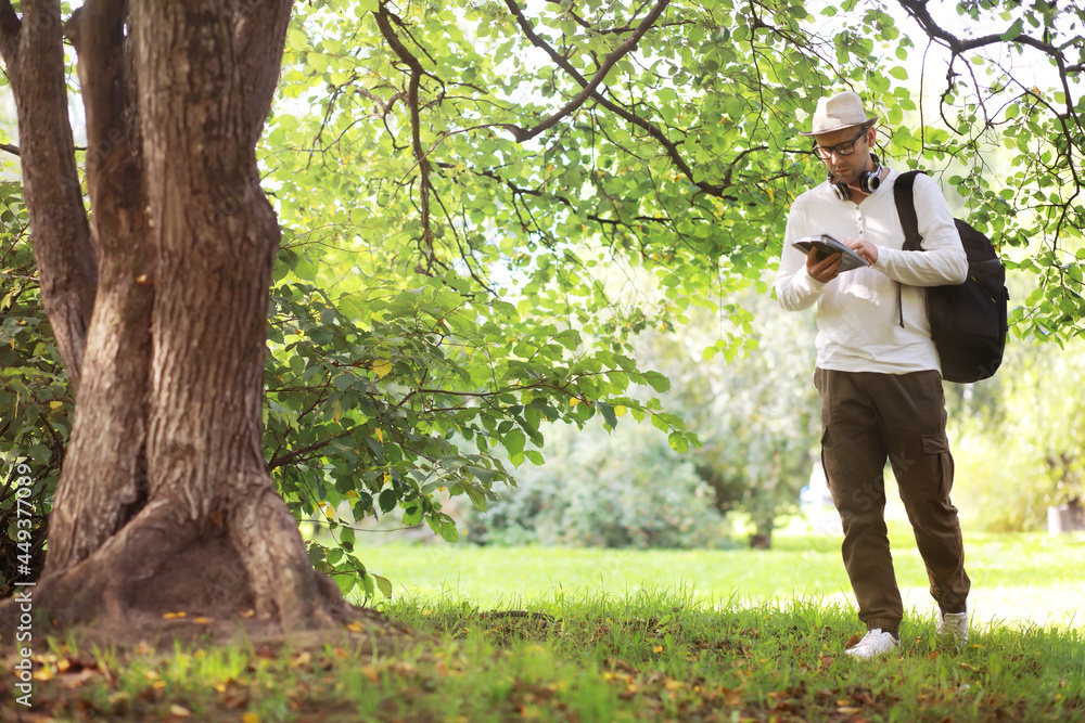 A man hides in the shade of trees on a hot day. Lunch break. Rest in the middle of the working day. A man hides in the shade of trees on a hot day. Lunch break. Rest in the middle of the working day.