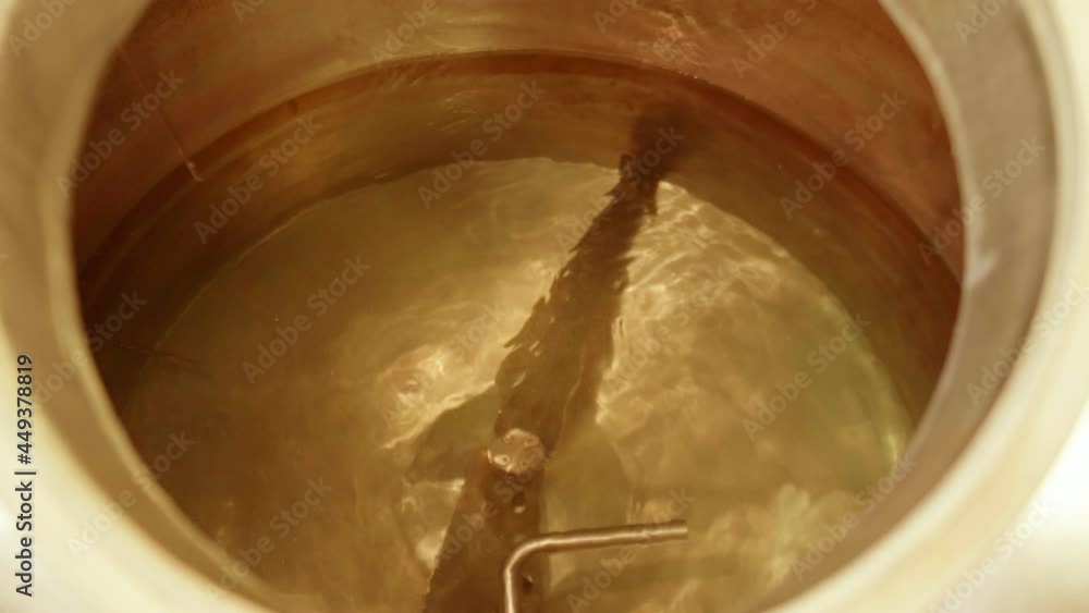 Pouring malt into the beer brewing unit Pouring malt into the beer brewing unit