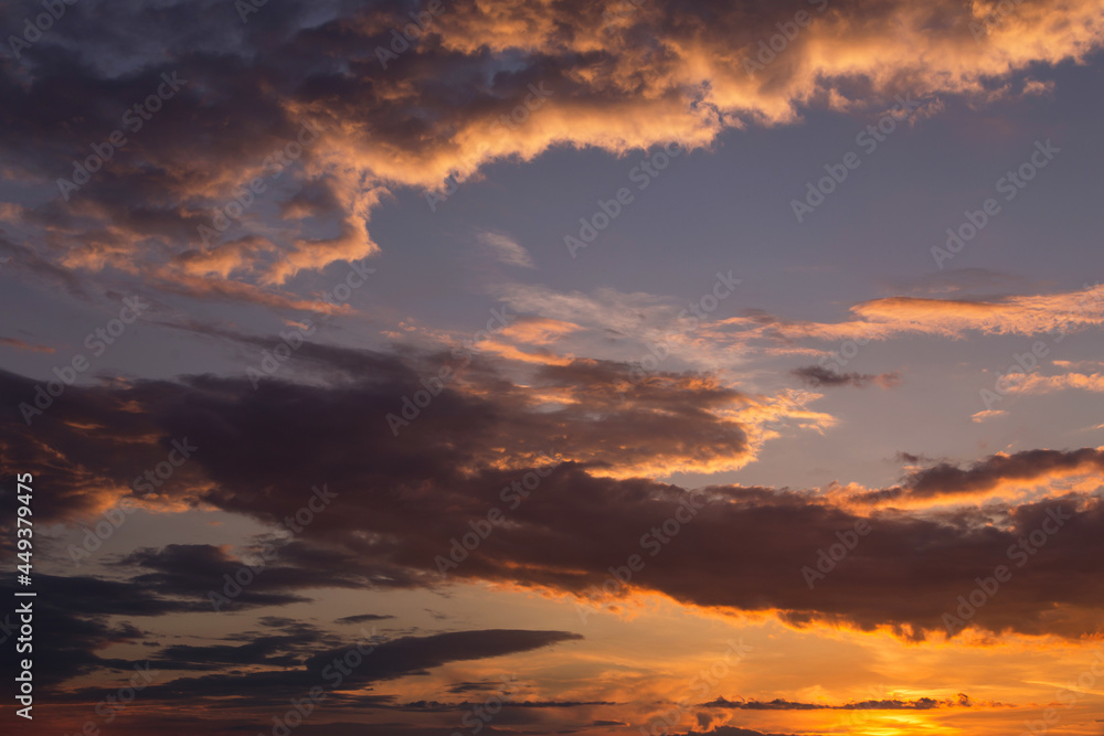 Fototapeta premium Dramatic sunrise, sunset yellow orange blue sky with clouds with sun and sunlight abstract background texture 