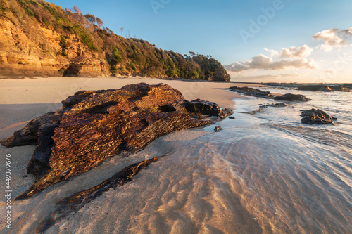 a rocky beach next to a body of water