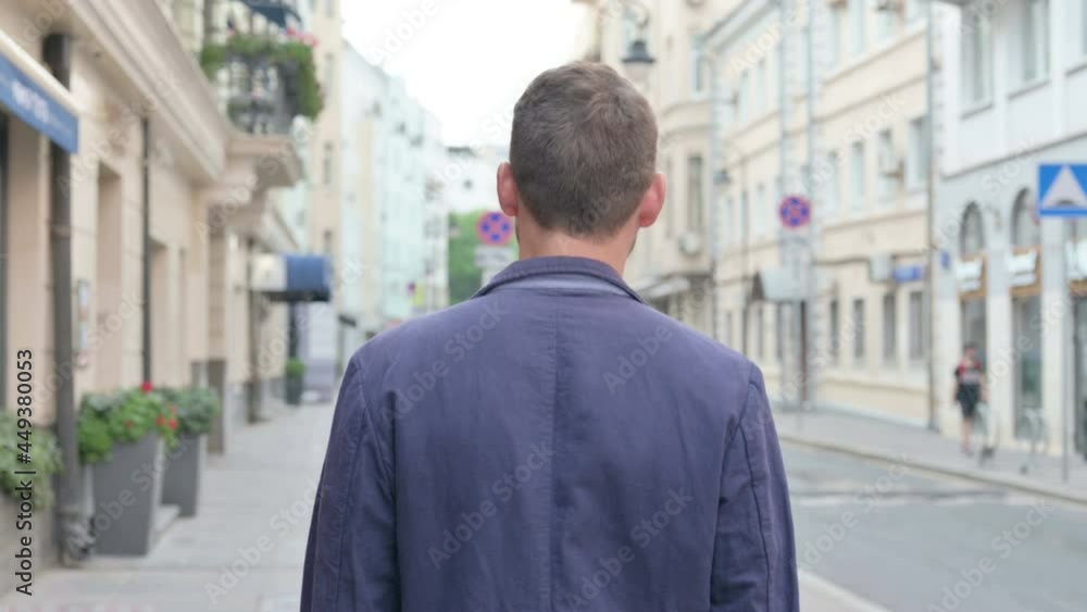 Back View of Mature Adult Man Walking in a Street Back View of Mature Adult Man Walking in a Street