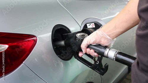 Man is refueling at gas station. Male hand filling benzine gasoline fuel in car. Petrol prices concept photo